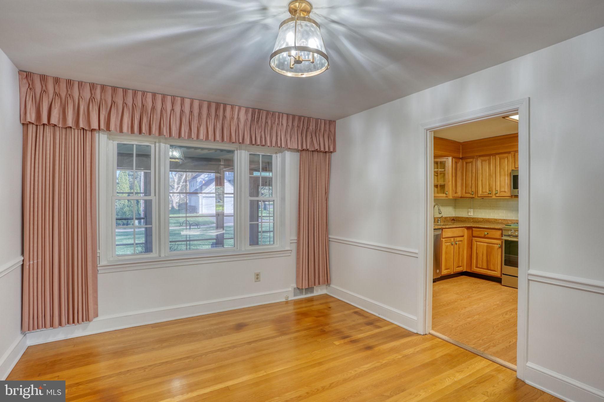 455 East Loockerman Street Dover, DE 19901 - Photo 12 of 55 a view of an empty room with wooden floor and a window