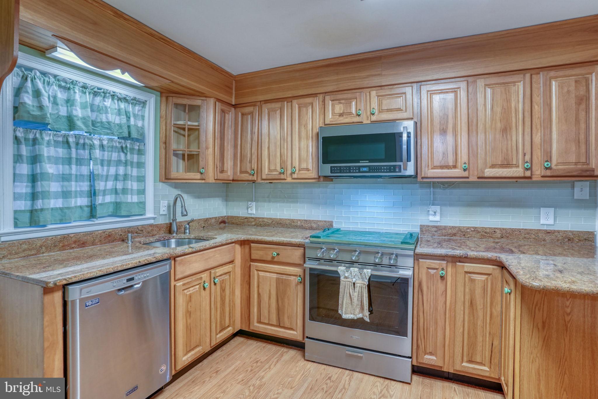 455 East Loockerman Street Dover, DE 19901 - Photo 15 of 55 a kitchen with stainless steel appliances granite countertop white cabinets sink and a granite counter top