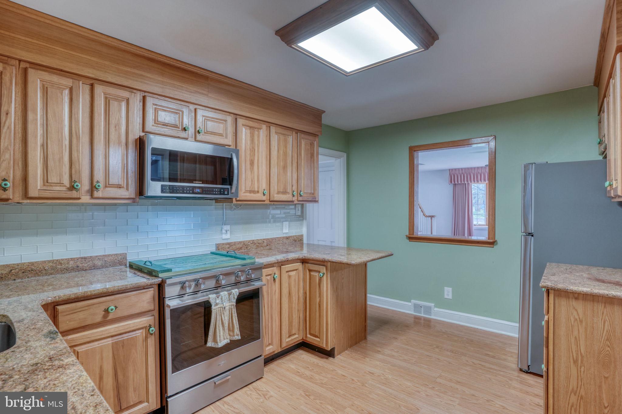 455 East Loockerman Street Dover, DE 19901 - Photo 16 of 55 a kitchen with stainless steel appliances granite countertop a stove microwave and sink