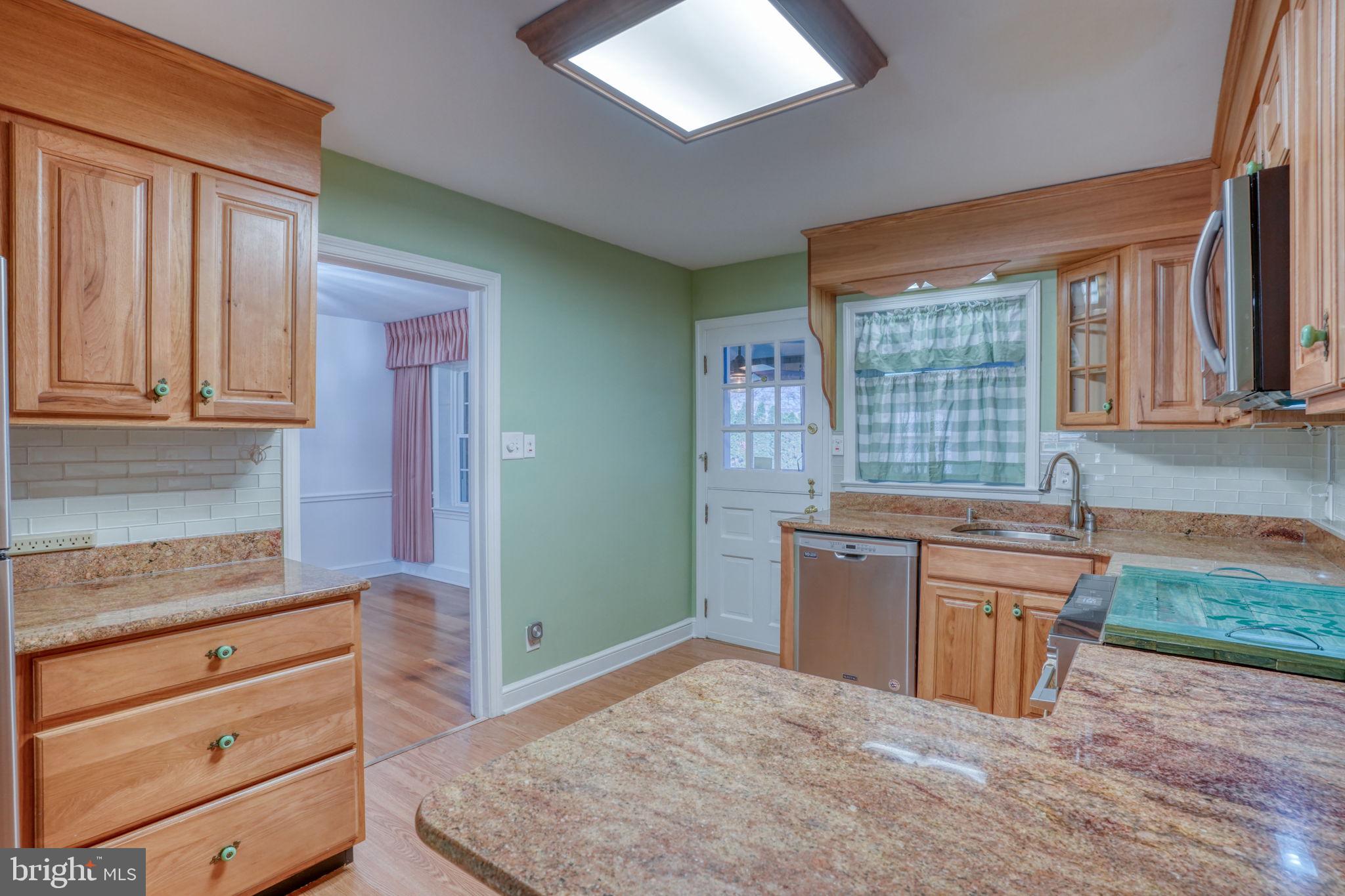 455 East Loockerman Street Dover, DE 19901 - Photo 19 of 55 a kitchen with stainless steel appliances granite countertop a stove a sink and a refrigerator