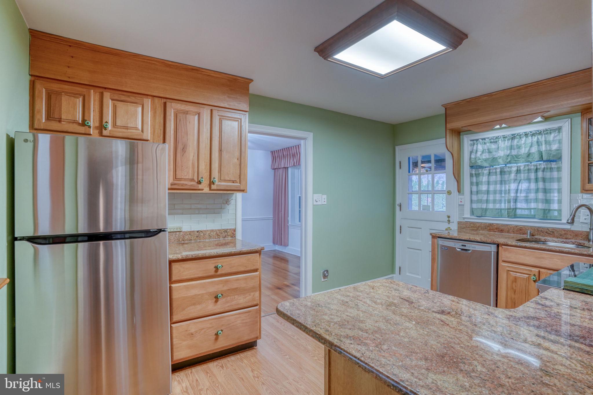 455 East Loockerman Street Dover, DE 19901 - Photo 20 of 55 a kitchen with granite countertop a refrigerator and a sink