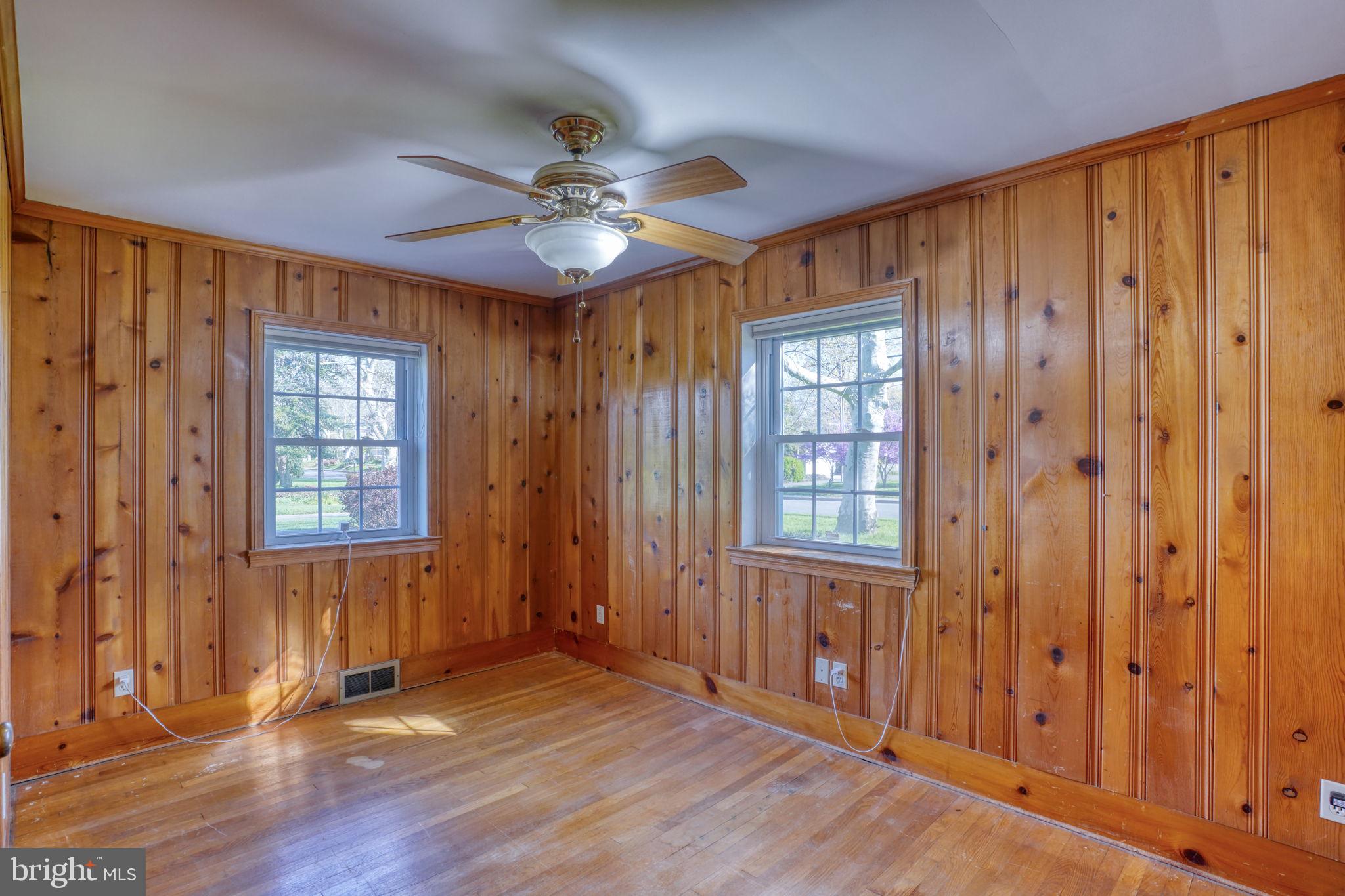455 East Loockerman Street Dover, DE 19901 - Photo 25 of 55 an empty room with wooden floor chandelier fan and windows