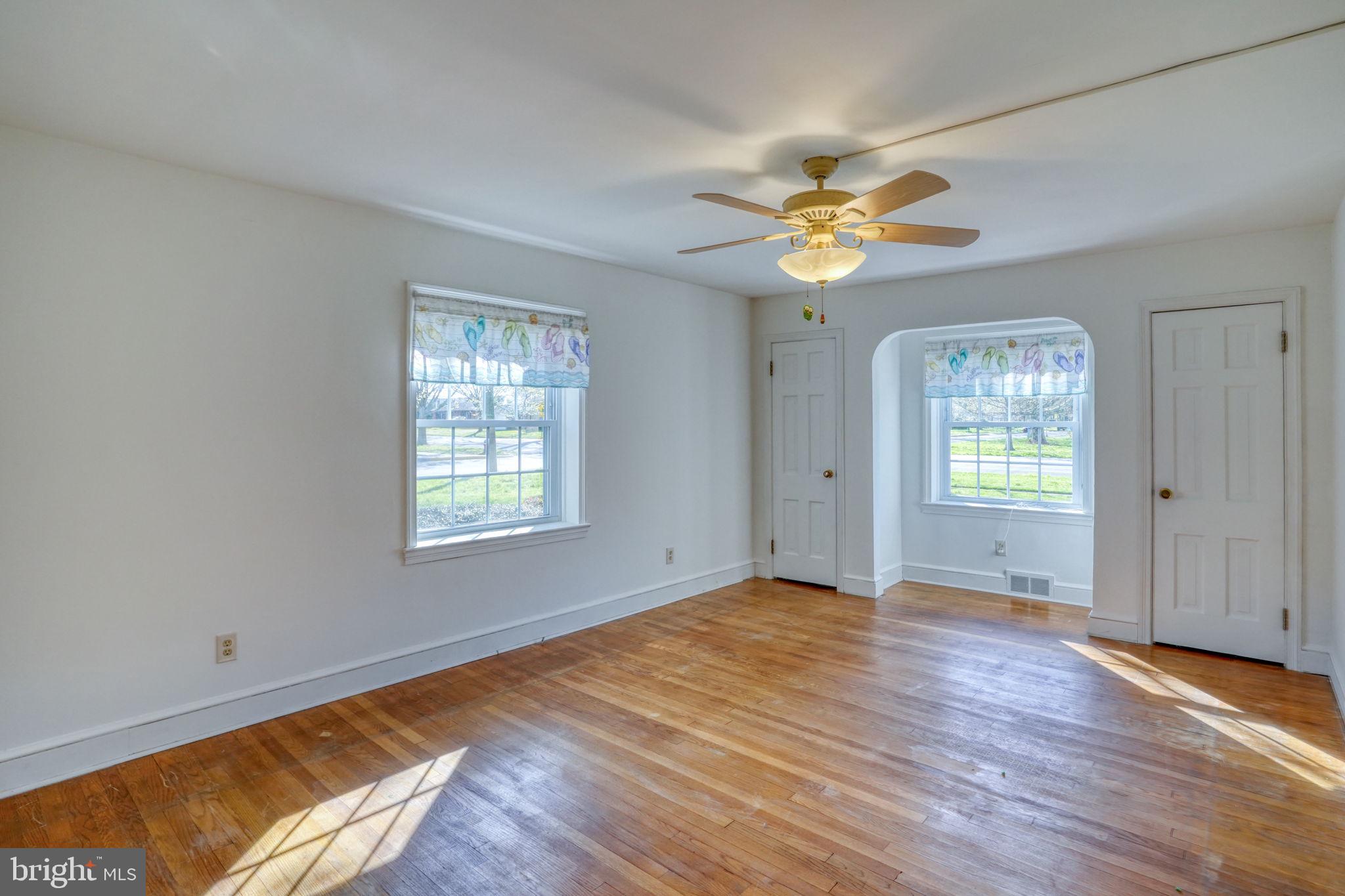 455 East Loockerman Street Dover, DE 19901 - Photo 27 of 55 a view of an empty room with window and wooden floor