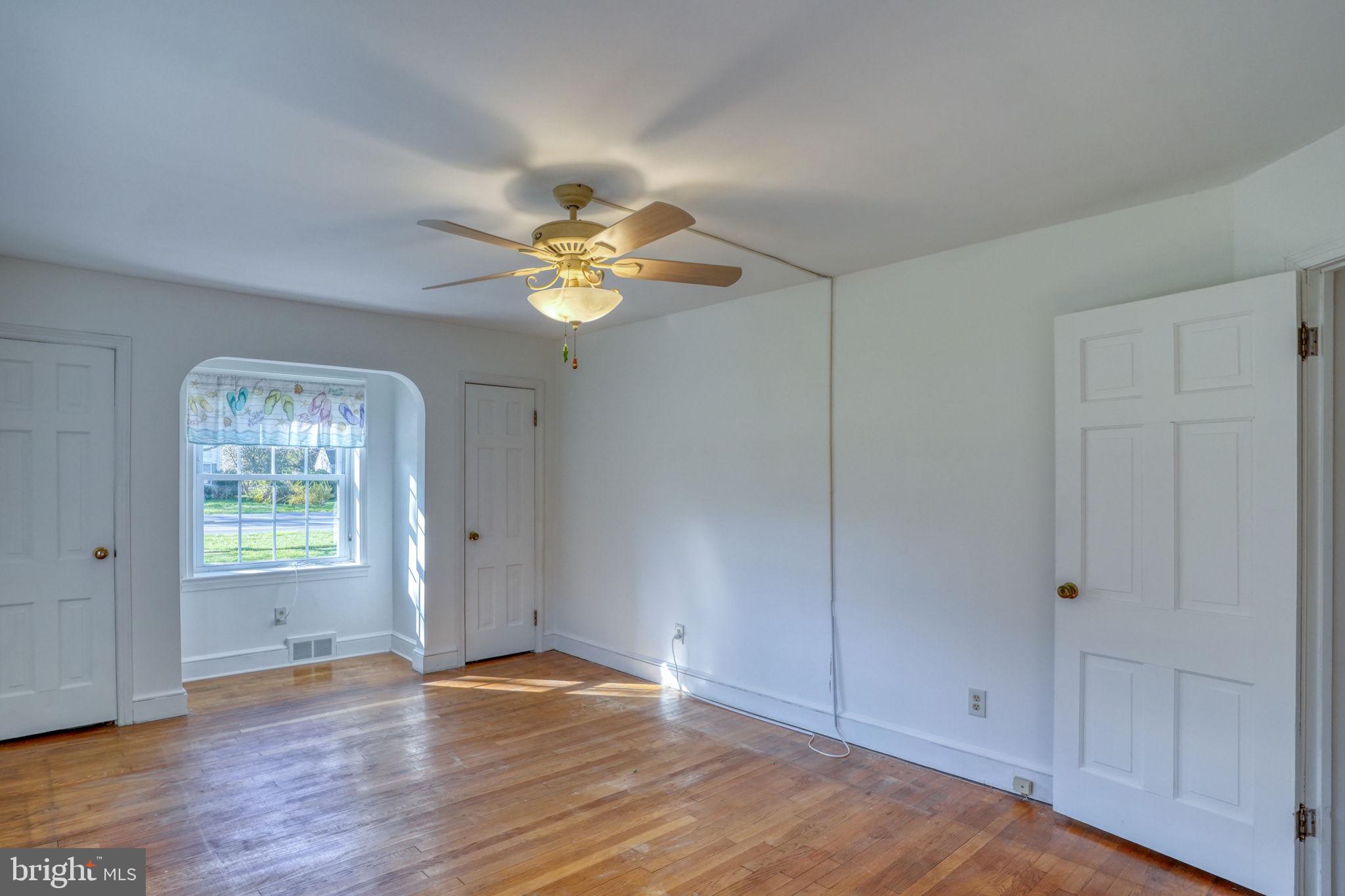455 East Loockerman Street Dover, DE 19901 - Photo 28 of 55 an empty room with wooden floor and window