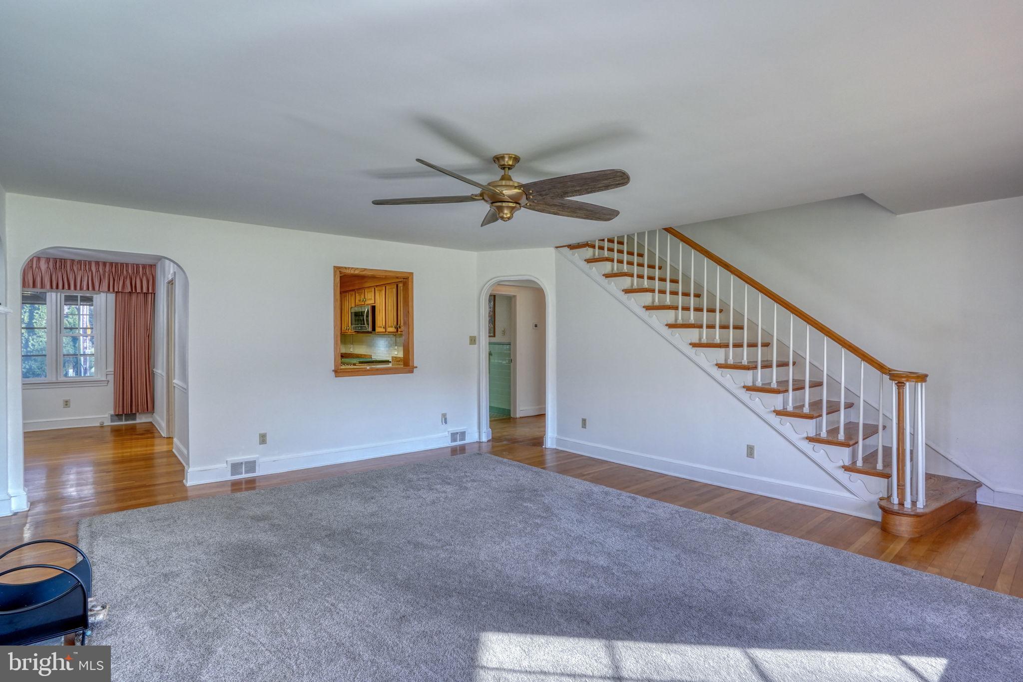 455 East Loockerman Street Dover, DE 19901 - Photo 10 of 55 a view of a livingroom with wooden floor and a ceiling fan