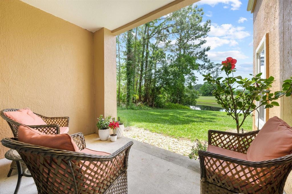 520 Florida Club Boulevard, Unit 104 St. Augustine, FL 32084 - Photo 13 of 20 a table and chairs in the garden