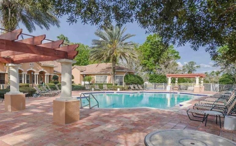 520 Florida Club Boulevard, Unit 104 St. Augustine, FL 32084 - Photo 14 of 20 a view of a house with backyard porch and sitting area