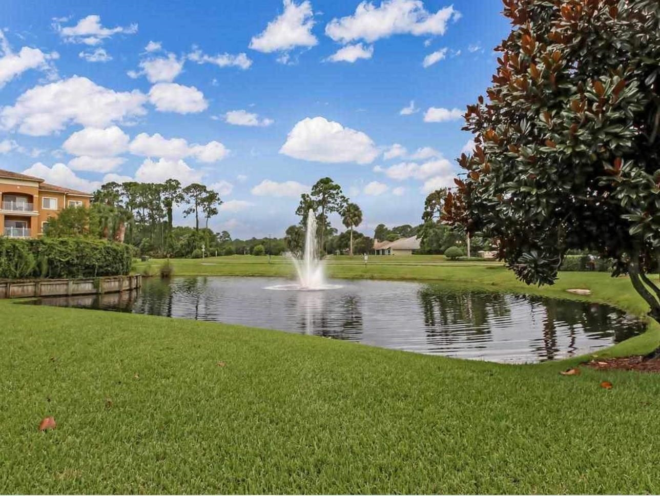 520 Florida Club Boulevard, Unit 104 St. Augustine, FL 32084 - Photo 18 of 20 a view of a lake with a yard