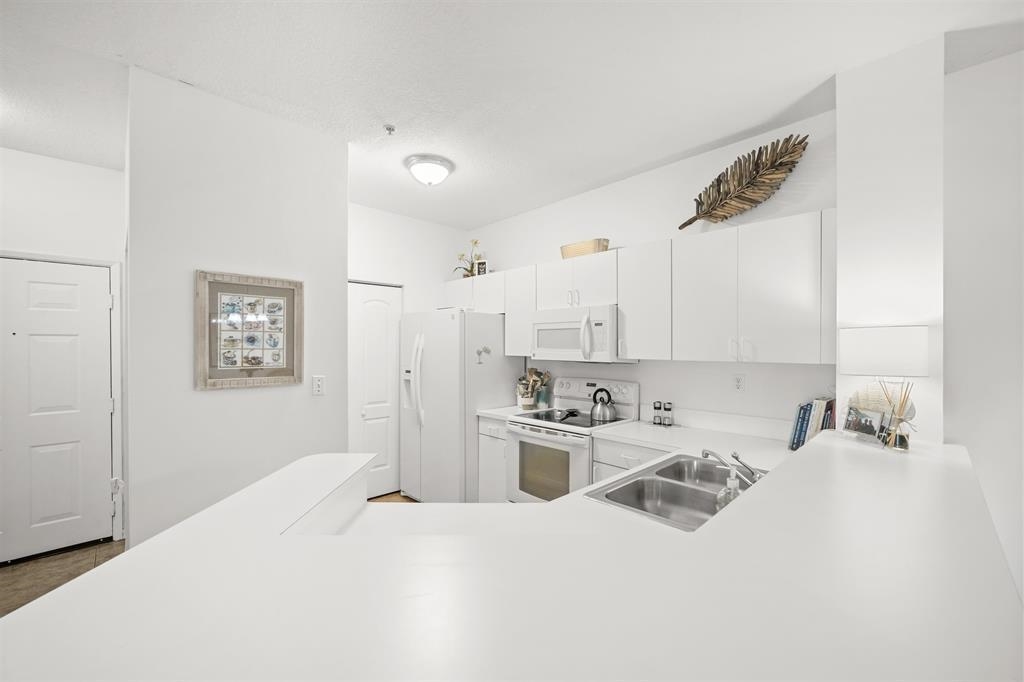 520 Florida Club Boulevard, Unit 104 St. Augustine, FL 32084 - Photo 8 of 20 a room with a bed and a cabinets