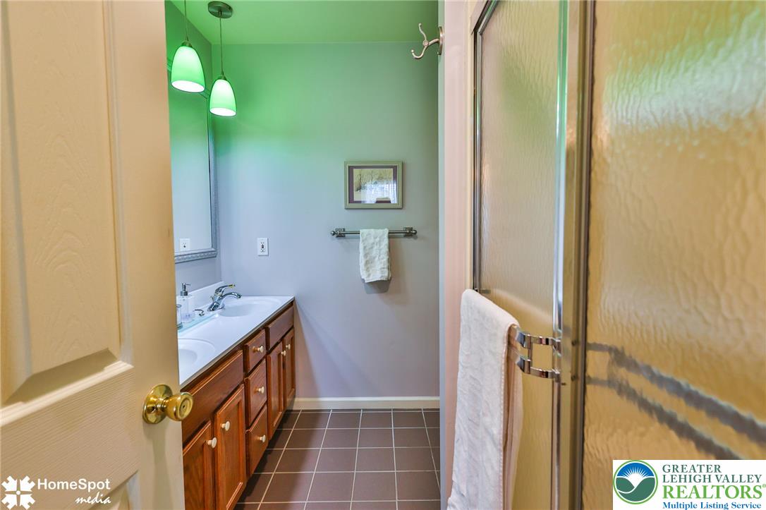 4191 Walter Road Bethlehem, PA 18020 - Photo 18 of 23 Dual vanities and a glass-enclosed shower create a practical and well-appointed bathroom space.