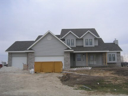 10283 East Shagbark Lane Rochelle, IL 61068 - Photo 1 of 2 a front view of a house with a yard and garage
