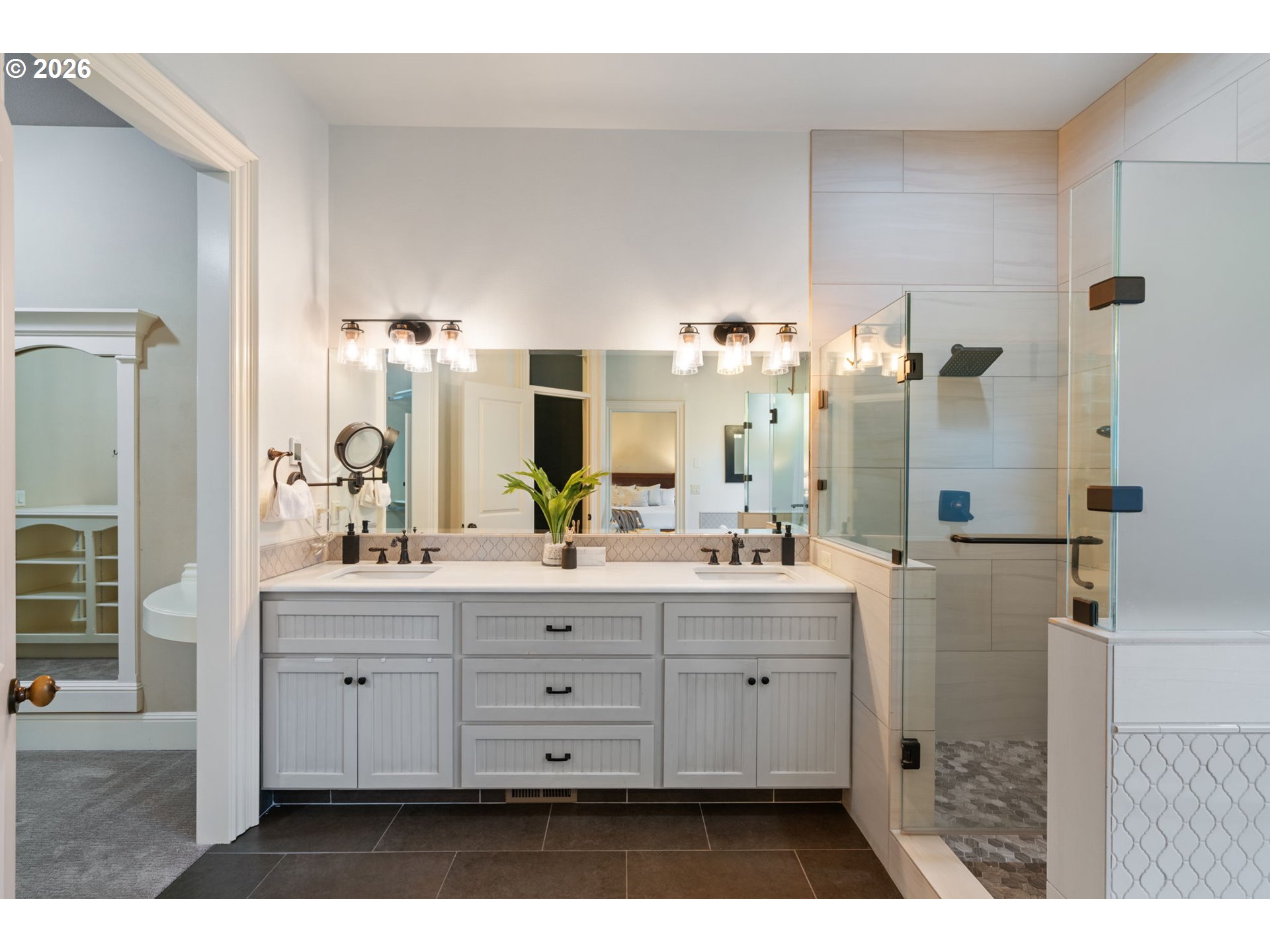 510 Northeast 224th Circle Ridgefield, WA 98642 - Photo 25 of 48 a bathroom with a double vanity sink a mirror and a shower