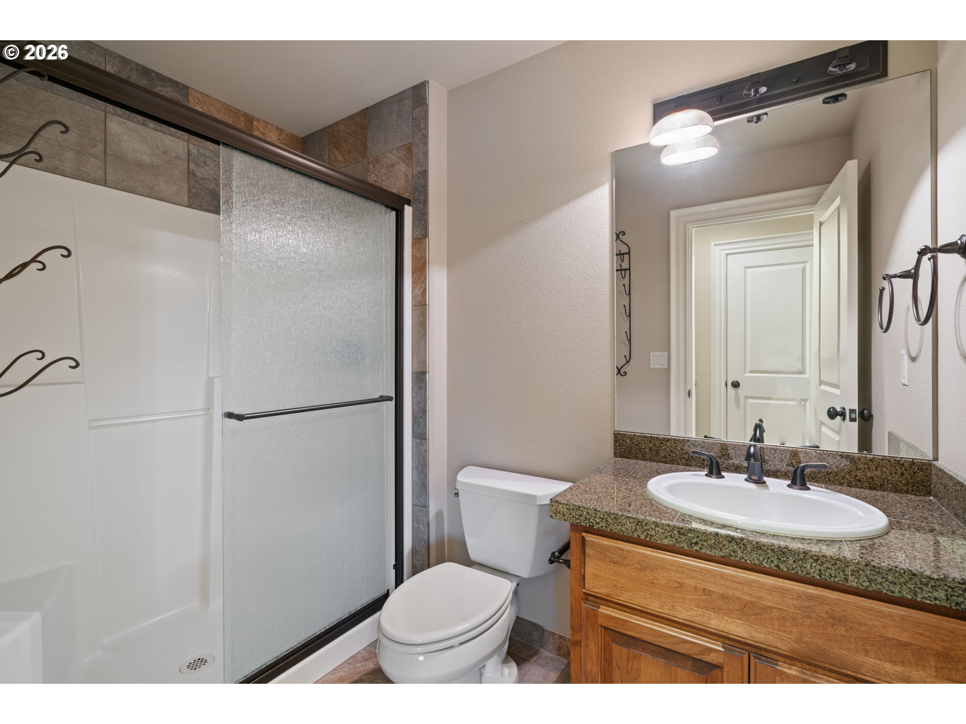 510 Northeast 224th Circle Ridgefield, WA 98642 - Photo 34 of 48 a bathroom with a granite countertop sink toilet and shower