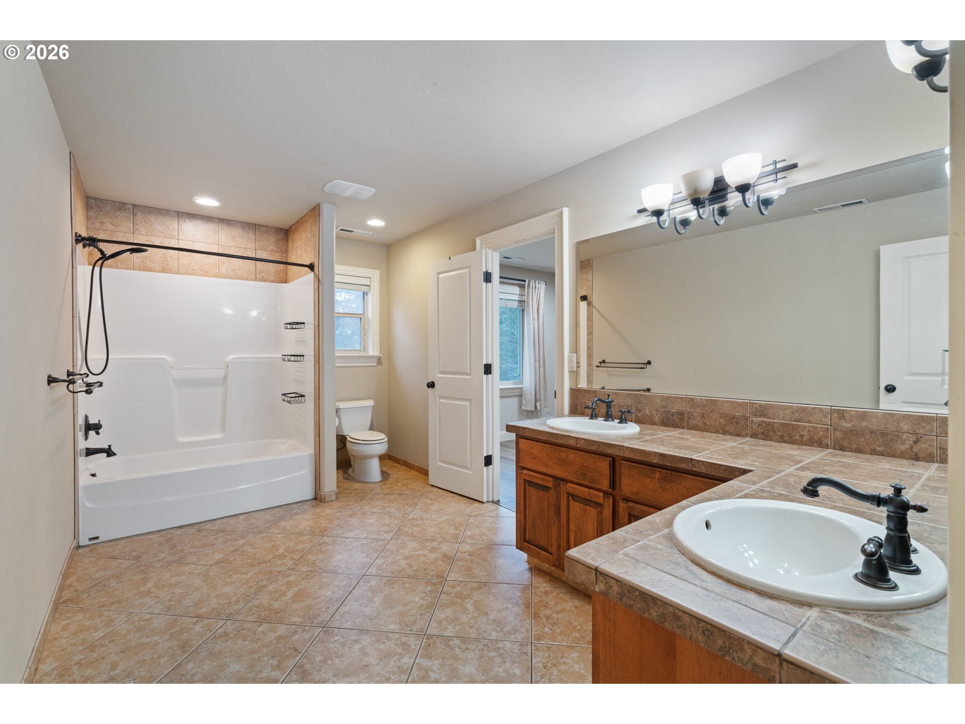 510 Northeast 224th Circle Ridgefield, WA 98642 - Photo 42 of 48 a bathroom with a sink double vanity granite tub shower and a mirror
