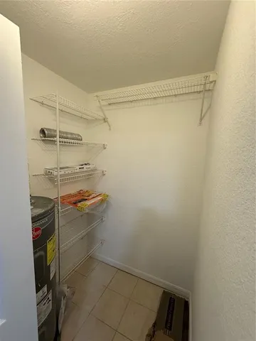 a kitchen with a refrigerator sink and cabinets