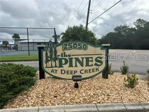 a kitchen with a refrigerator a stove a sink and white cabinets