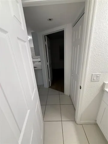 an empty room with a window and ceiling fan