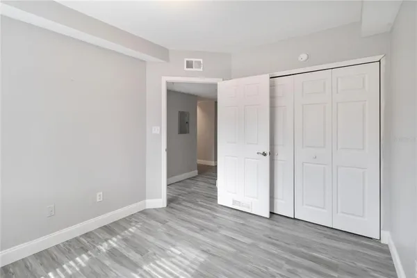 a view of an empty room and wooden floor