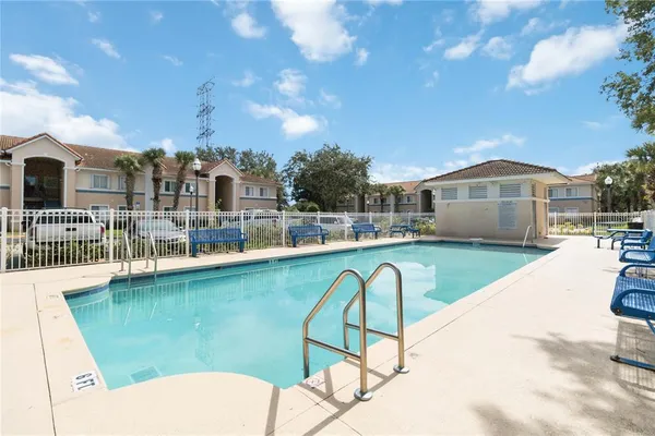 a swimming pool with outdoor seating and yard
