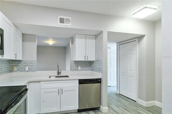 a kitchen with stainless steel appliances granite countertop a sink and cabinets