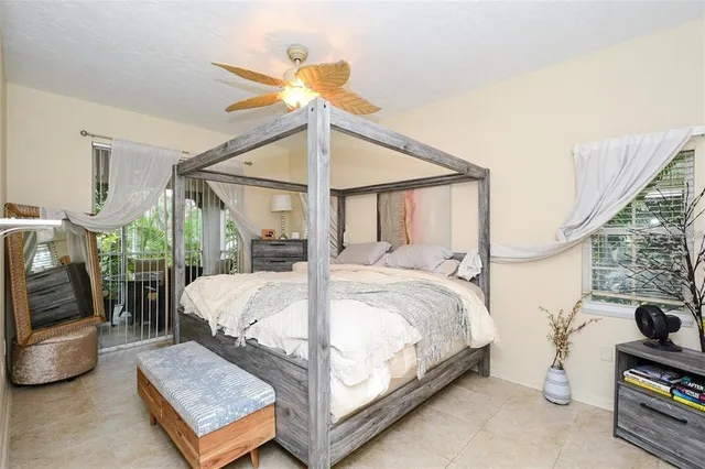 a bed sitting in a bedroom next to a window