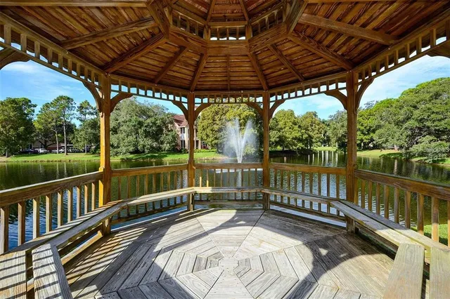 a view of a balcony with wooden floor and outdoor seating