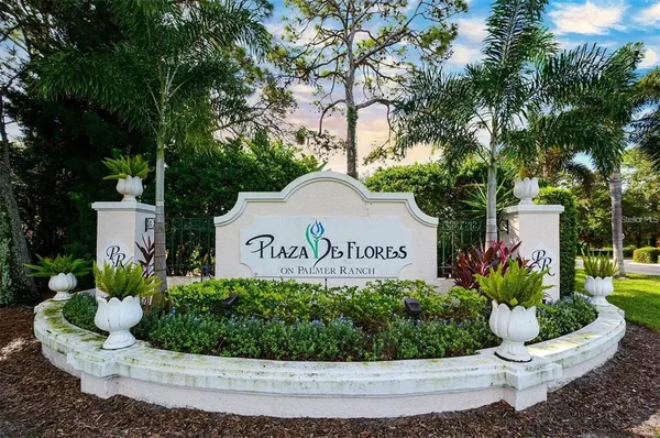 a sign that is sitting in front of flowers