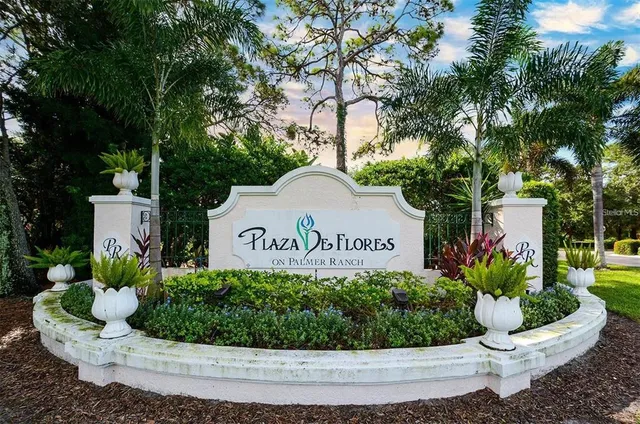 a sign that is sitting in front of flowers