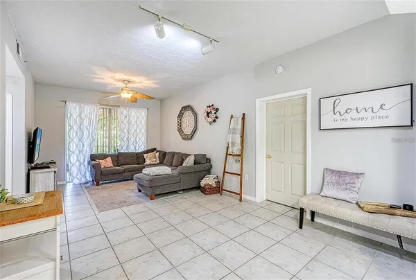 a living room with furniture and a potted plant