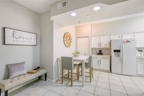 a kitchen with a cabinets and a refrigerator