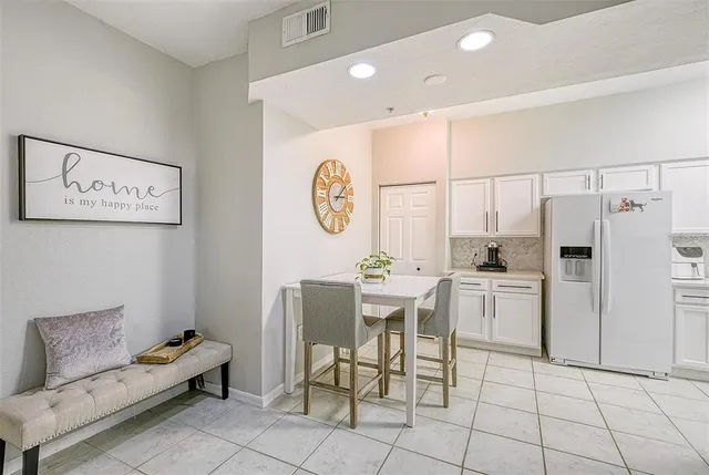 a kitchen with a cabinets and a refrigerator