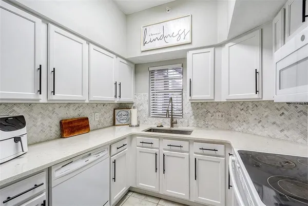 a kitchen with stainless steel appliances white cabinets and a sink