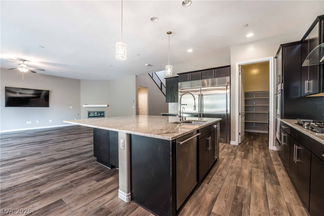 2787 Athens Ridge Drive Henderson, NV 89052 - Photo 8 of 31 A spacious, open-concept design connects the sleek kitchen island to the living area.