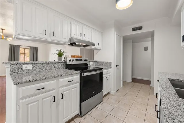 a kitchen with appliances cabinets and a sink