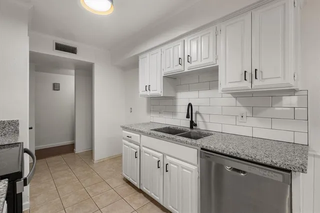 a kitchen with stainless steel appliances granite countertop a sink and a stove