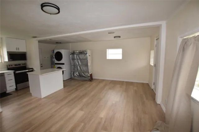a view of kitchen with furniture and wooden floor