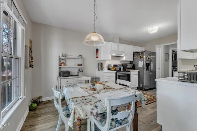 a kitchen with kitchen island a refrigerator stove microwave and cabinets