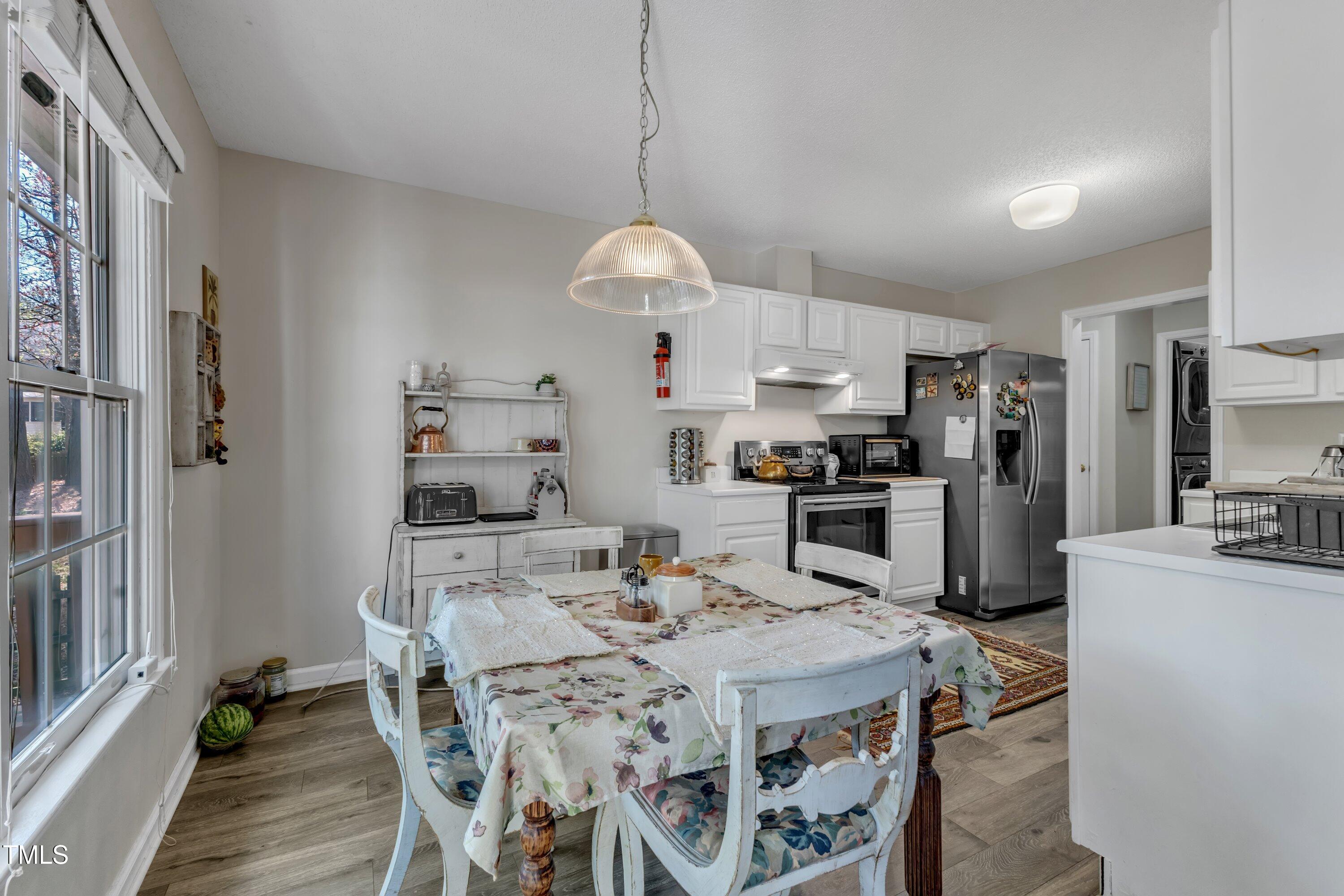 9512 Anson Grove Lane Raleigh, NC 27615 - Photo 12 of 39 a kitchen with kitchen island a refrigerator stove microwave and cabinets