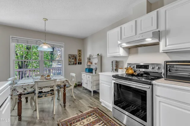 a kitchen with stainless steel appliances kitchen island granite countertop a stove a sink and a refrigerator