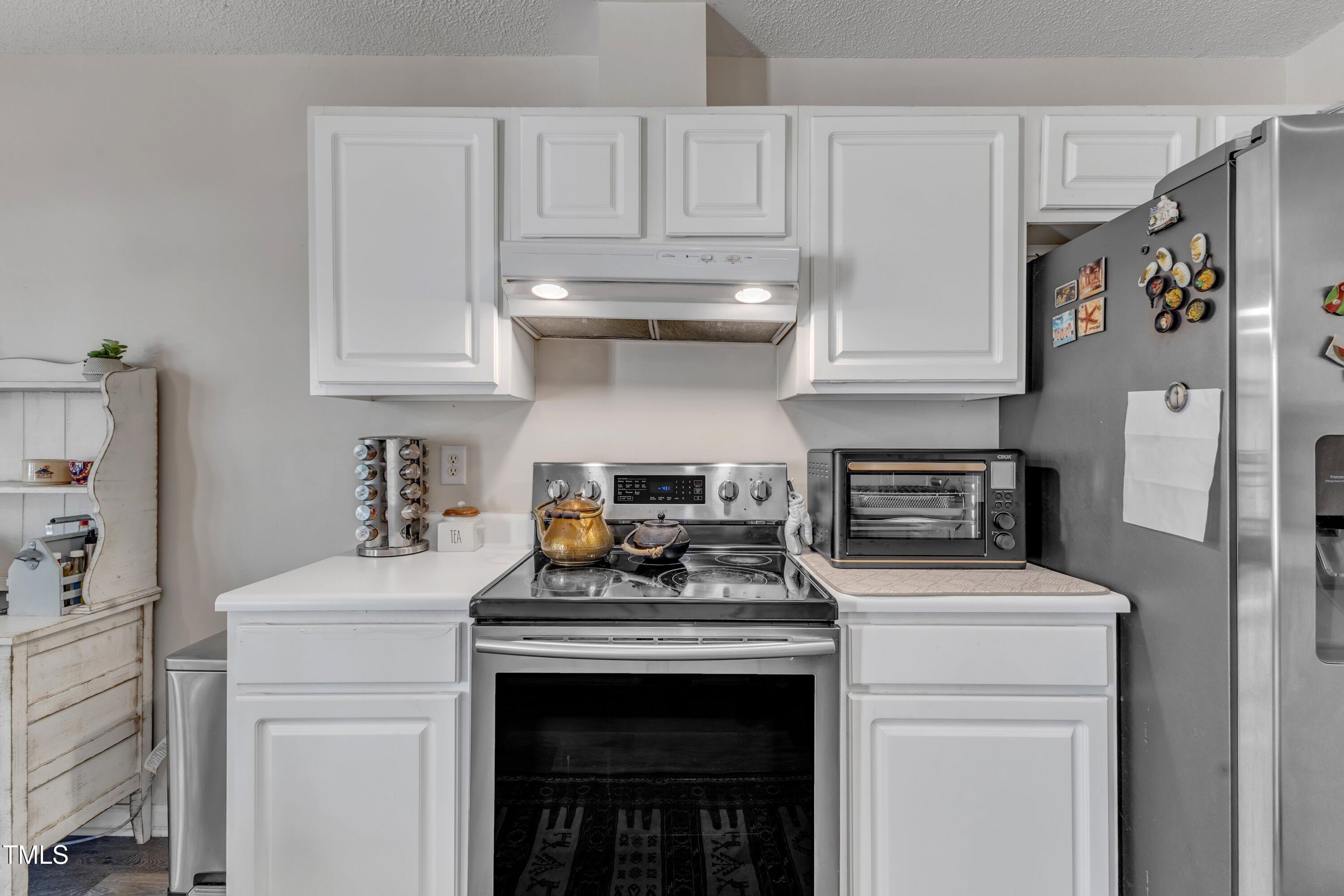 9512 Anson Grove Lane Raleigh, NC 27615 - Photo 15 of 39 a kitchen with stainless steel appliances granite countertop a stove a refrigerator and a sink