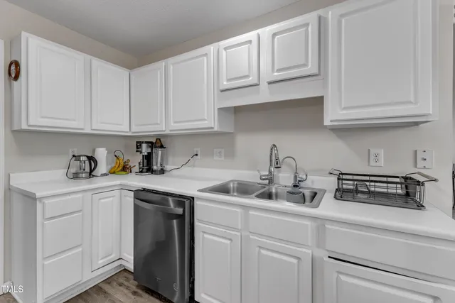 a kitchen with white cabinets and white appliances