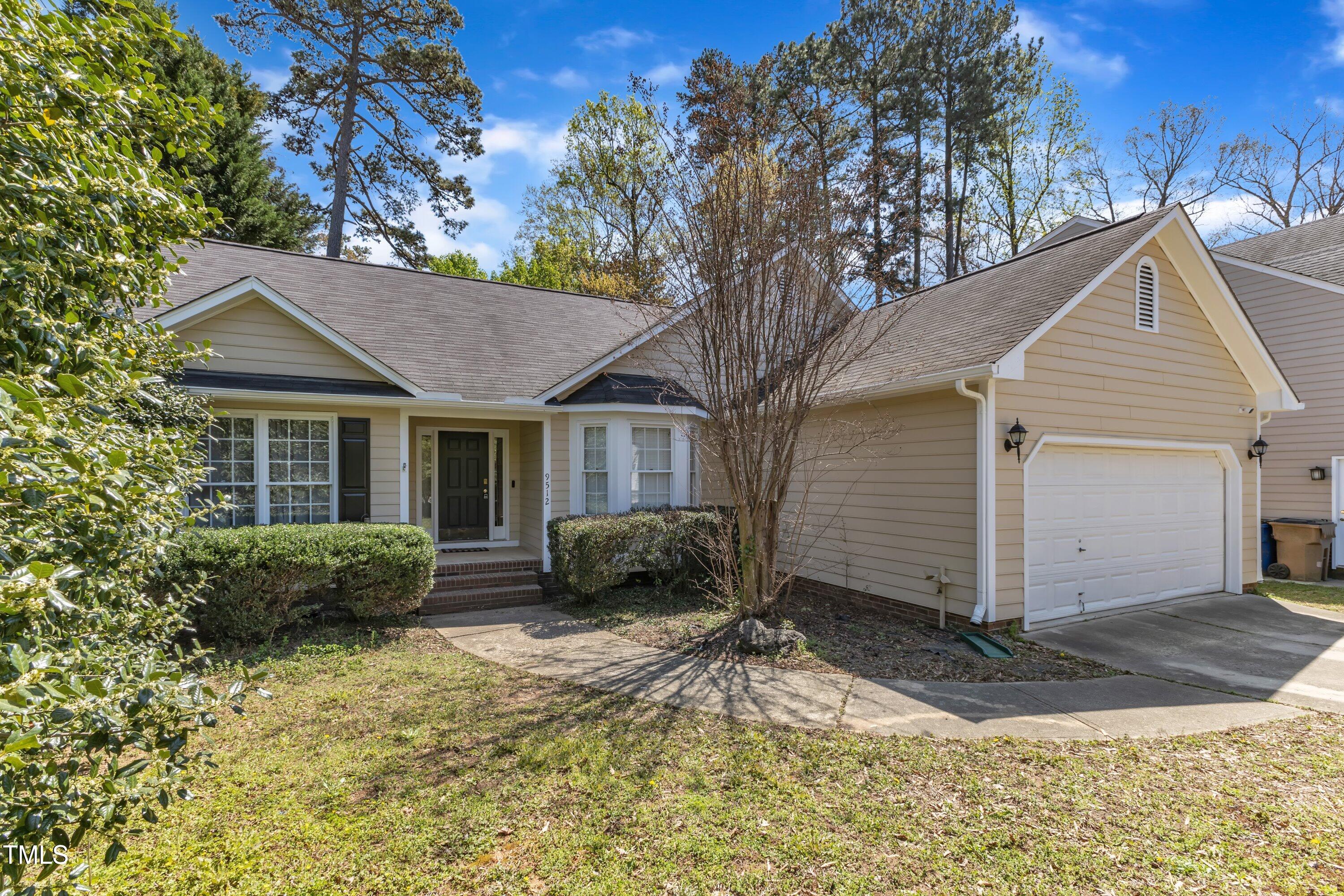 9512 Anson Grove Lane Raleigh, NC 27615 - Photo 2 of 39 a front view of a house with a yard and potted plants