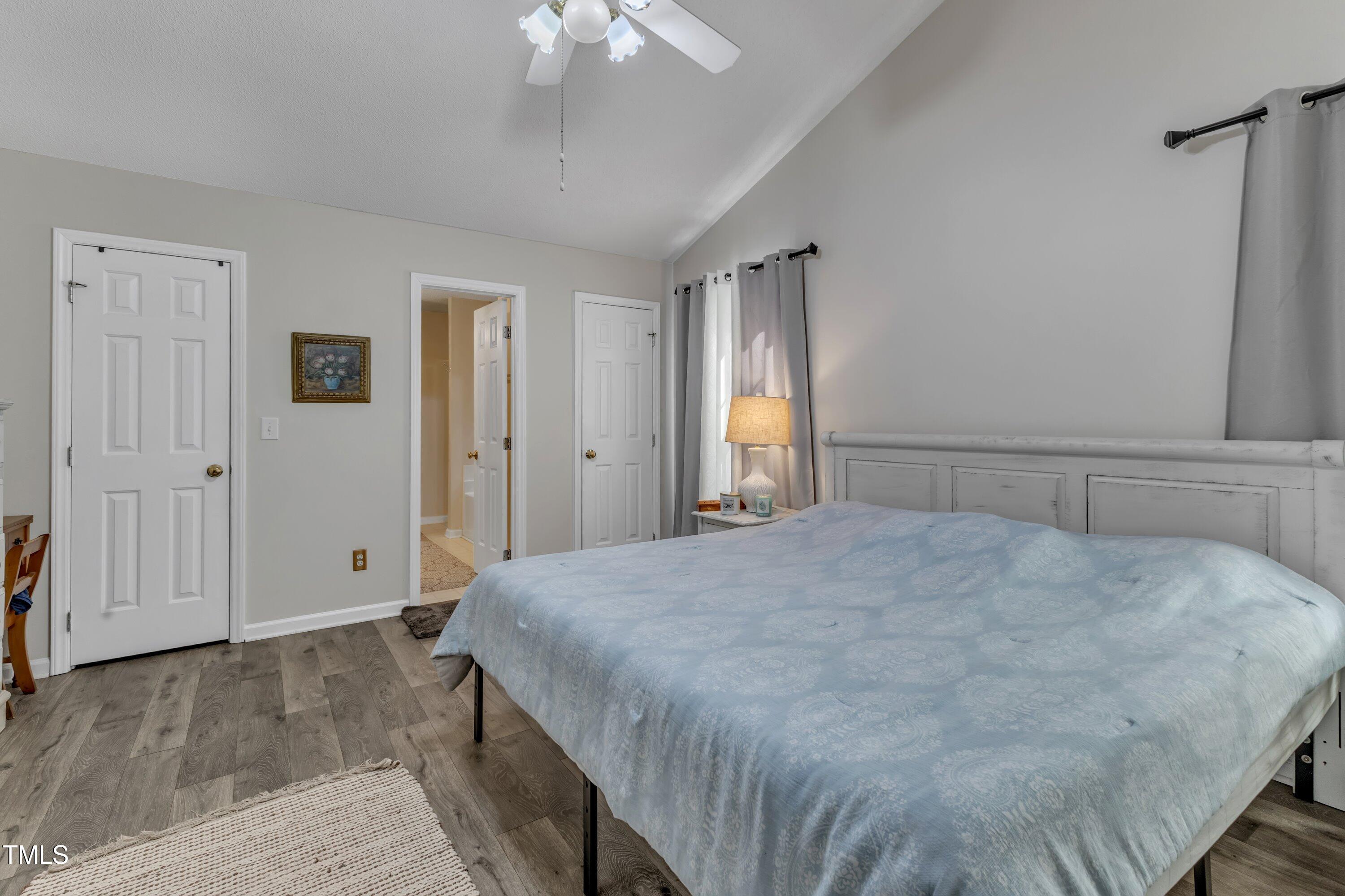 9512 Anson Grove Lane Raleigh, NC 27615 - Photo 21 of 39 a spacious bedroom with a bed and a chandelier