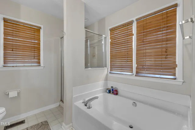 a white bath tub sitting next to a window