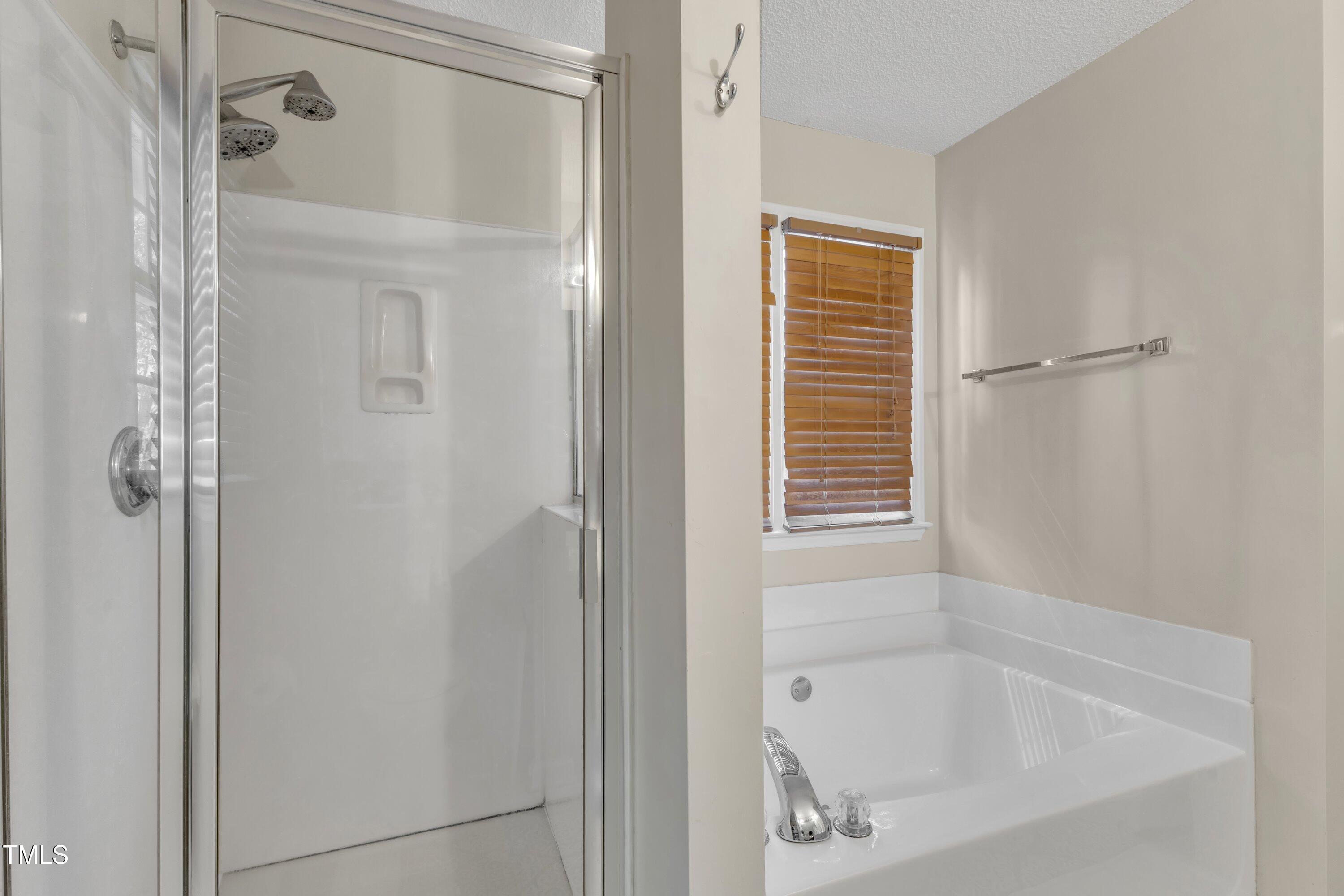 9512 Anson Grove Lane Raleigh, NC 27615 - Photo 24 of 39 a white bath tub with shower