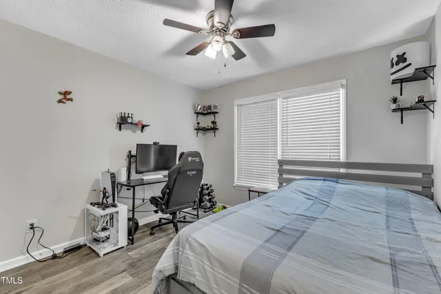 a bedroom with a bed a desk and chair