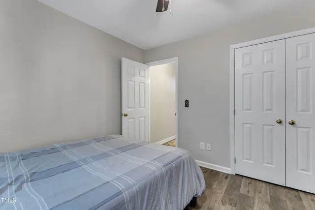 a bedroom with bed and a baby bed