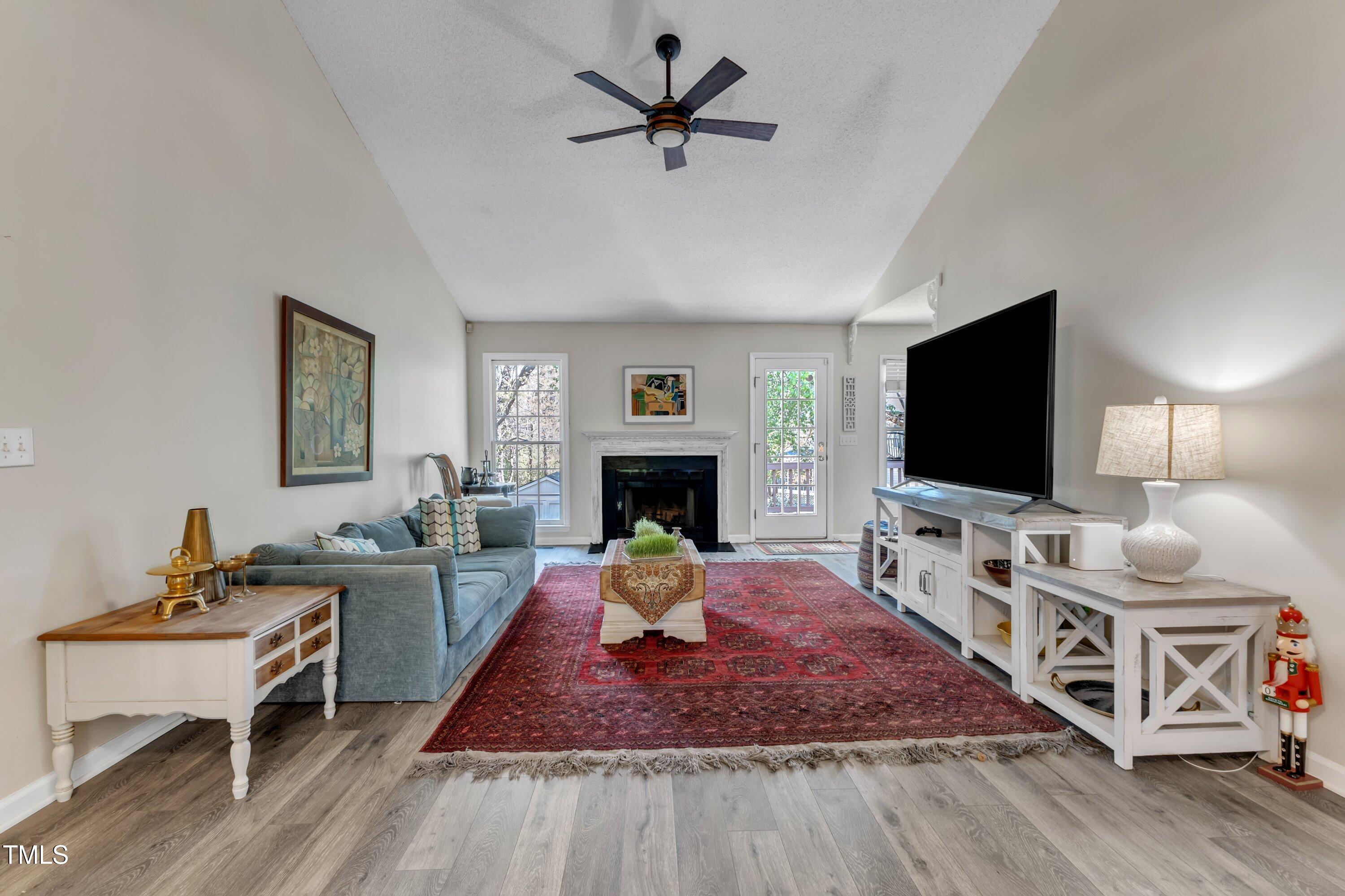 9512 Anson Grove Lane Raleigh, NC 27615 - Photo 5 of 39 a living room with furniture and a flat screen tv