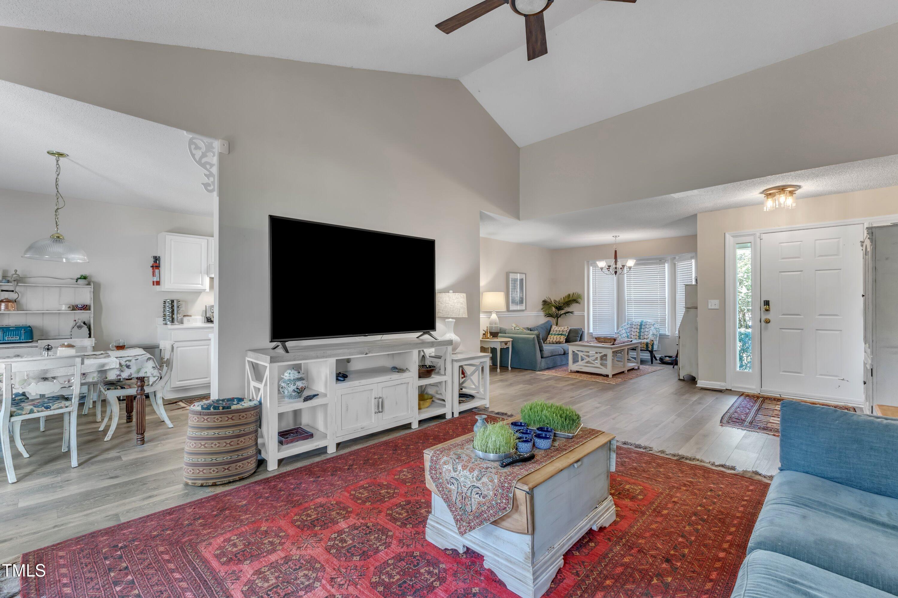 9512 Anson Grove Lane Raleigh, NC 27615 - Photo 8 of 39 a living room with furniture and a flat screen tv
