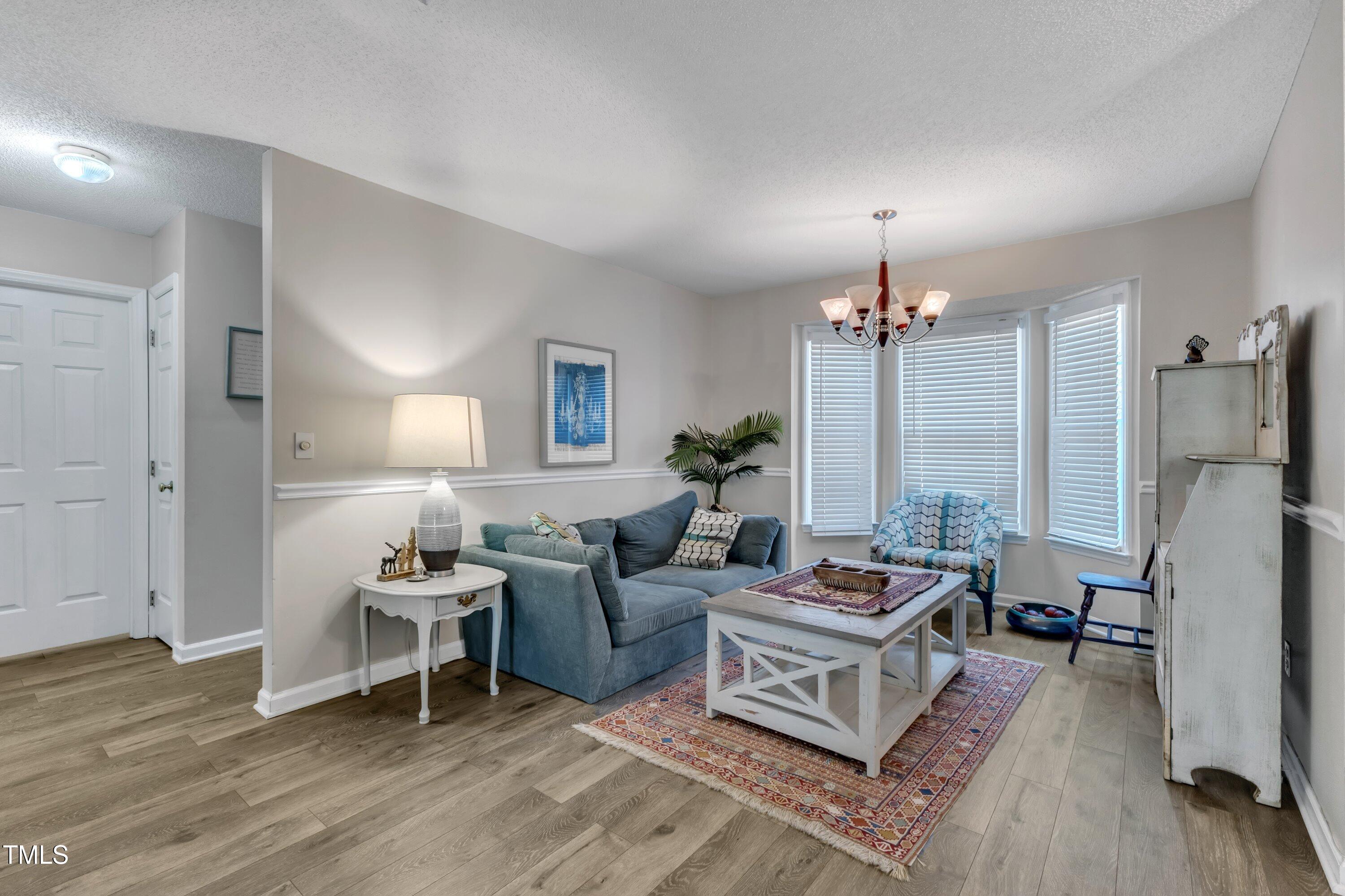 9512 Anson Grove Lane Raleigh, NC 27615 - Photo 9 of 39 a living room with furniture window and a table